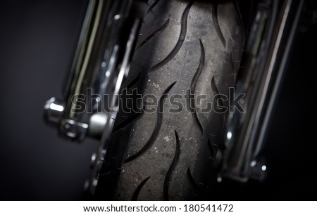 Color shot of a motorcycle forks and tire.