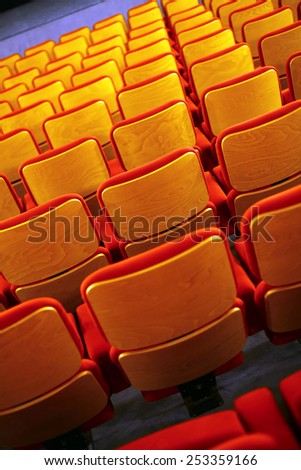 Color vertical shot of some seats in a cinema hall.