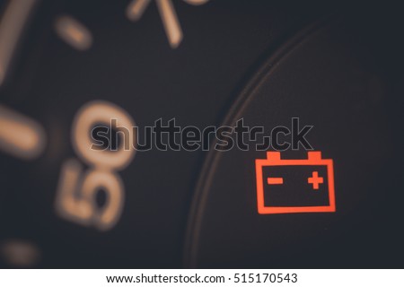 Close up shot of a car's dashboard with the battery icon lit. Foto stock © 