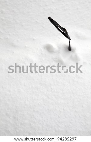 Picture of a windscreen wiper on a windscreen full of snow