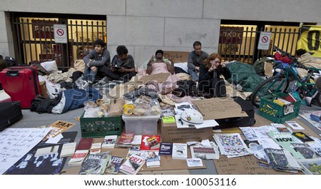 NEW YORK - APRIL 13: Unidentified demonstrators with \'Occupy Wall Street\' on the sidewalk of Broad street and Wall street in Manhattan on April 13, 2012 in New York.