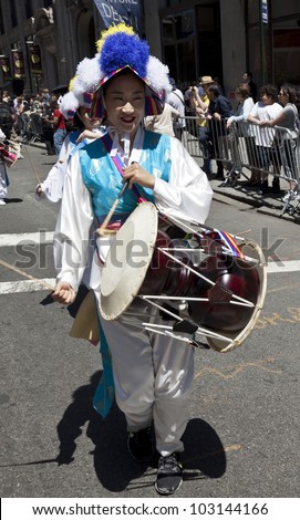 NEW YORK - MAY 19: Member of Korean Music and Dance Institute of Flashing Queens performs on Broadway as part of New York Dance Parade on May 19, 2012 in New York City