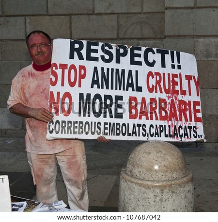 BARCELONA, SPAIN - MAY 04: Luis dressed as wounded animal protest against bullfighting on plaza in front of municipal building in Barcelona, Spain on May 04, 2012