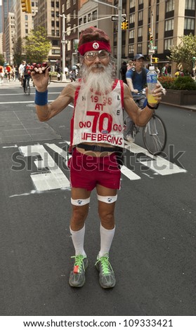 NEW YORK - AUGUST 04: James Lu marathon runner since 1938 runs along Park Avenue during Summer Streets sponsored by Department of Transportation on Park Avenue in Manhattan on August 4, 2012 in NYC