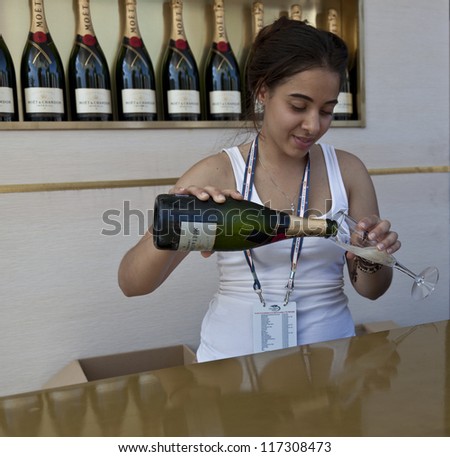 NEW YORK - AUGUST 28: Bartender serves Moet & Chandon flute of champagne at US Open tennis tournament on August 28, 2012 in Flushing Meadows New York