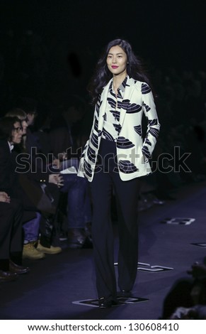 NEW YORK - FEBRUARY 10: Model walks runway as Fran Lebowitz watches during Fall/Winter 2013 presentation for DVF collection at Mercedes-Benz Fashion Week at Lincoln Center on Feb 10, 2013 in New York