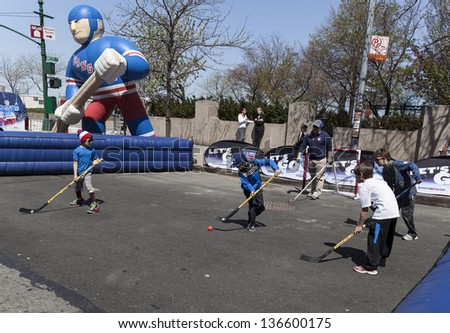 NEW YORK - APRIL 27: Kids play hockey sponsored by ESPN and New York Rangers at Family festival during the 2013 Tribeca Film festival on Greenwich street on April 27, 2013 in New York City