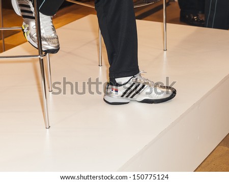 NEW YORK - AUGUST 19: Novak Djokovic wears Adidas sneakers with Serbian flag at launch of UNIQLO tennis apparel modeled after Novak Djokovic at 5th Avenue flagship store on August 19, 2013 in New York