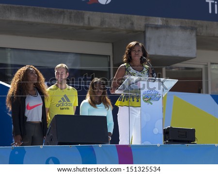 NEW YORK - AUGUST 24: First Lady Michelle Obama speaks on stage while tennis players watch during Arthur Ashe Kids Day presentation at Billie Jean King National Tennis Center on August 24, 2013 in NYC