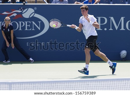 NEW YORK - AUGUST 27: Milos Raonic of Canada returns ball during 1st round match against Thomas Fabbiano of Italy at 2013 US Open at USTA Billie Jean King Tennis Center on August 27, 2013 in NYC