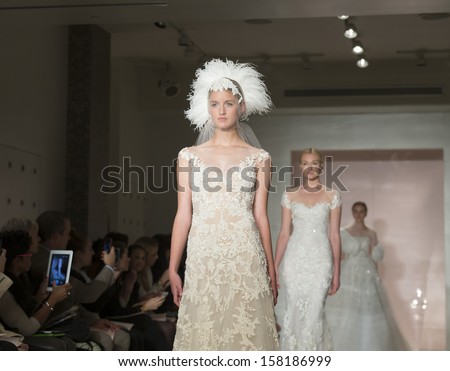 NEW YORK - OCTOBER 11: Models walk runway for Reem Acra during Bridal Week at 5th Avenue studio on October 11, 2013 in New York City