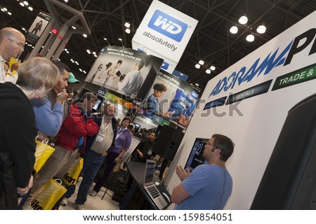 NEW YORK - OCTOBER 24: Unidentified attendees participate in presentation by Tim Grey at Adorama booth at Photoplus expo organized by PDN at Javits Convention Center on October 24, 2013 in NYC