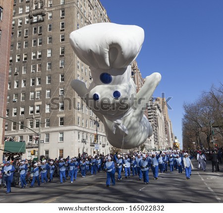 NEW YORK - NOVEMBER 28: Pillsbury Doughboy balloon is flown low because of weather condition at the 87th Annual Macy\'s Thanksgiving Day Parade on November 28, 2013 in New York City.