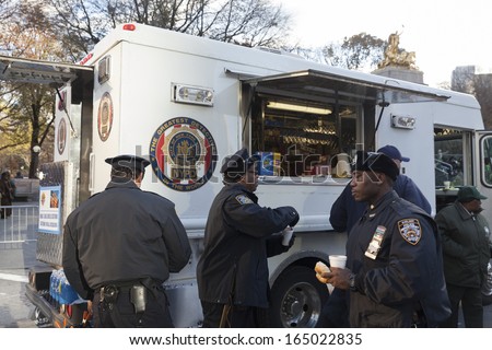 NEW YORK - NOVEMBER 28: Police detectives union provide hot breakfast in food truck in cold weather at the 87th Annual Macy\'s Thanksgiving Day Parade on November 28, 2013 in New York City.