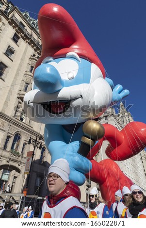 NEW YORK - NOVEMBER 28: Papa Smurf balloon is flown low because of weather condition at the 87th Annual Macy\'s Thanksgiving Day Parade on November 28, 2013 in New York City.