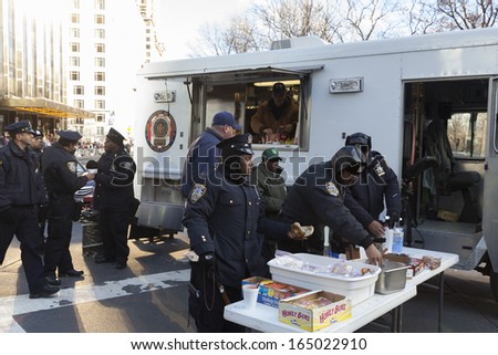NEW YORK - NOVEMBER 28: Police detectives union provide hot breakfast in food truck in cold weather at the 87th Annual Macy\'s Thanksgiving Day Parade on November 28, 2013 in New York City.