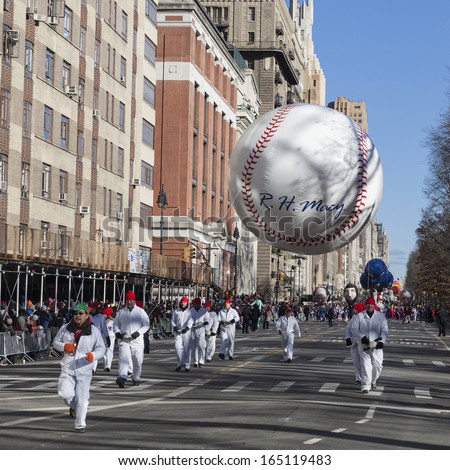 NEW YORK - NOVEMBER 28: R. H. Macy baseball balloon is flown low because of weather condition at the 87th Annual Macy\'s Thanksgiving Day Parade on November 28, 2013 in New York City.