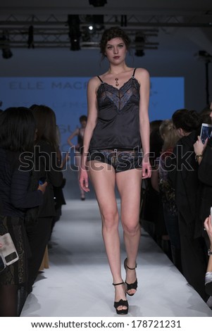 NEW YORK, NY - FEBRUARY 24, 2014: Model walks runway for Lingerie fashion night IN show by Pleasure State, Evollove, Elle Macpherson during CurveExpo at Tribeca Skyline Studios