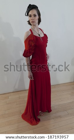 NEW YORK, NY - APRIL 13, 2014: Model shows off evening gown and hat for Junko Yoshioka runway show during bridal week at Studio Arte on 37th Street
