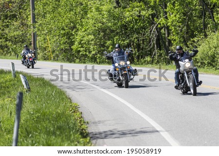 Tuxedo, NY USA - MAY 25, 2014: Unidentified members of Shameless Few motorcycle club ride on the road