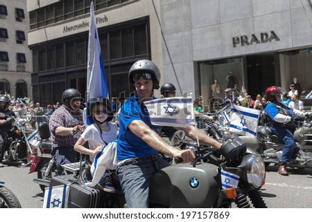 New York, NY USA - June 01, 2014: Father and daughter ride motorcycle during 50th annual Israeli Day parade on 5th Avenue in Manhattan