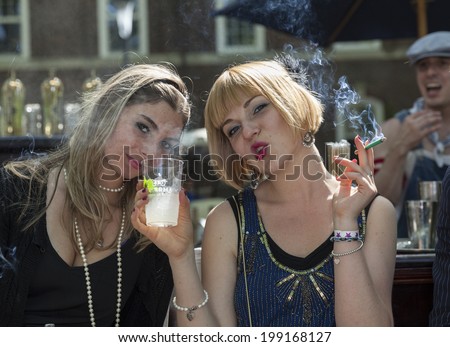 New York, USA - June 15, 2014: Attendies smoke at the St. Germain bar during 9th annual Jazz Age lawn party by Michael Arenella & the Dreamland Orchestra on Governors Island