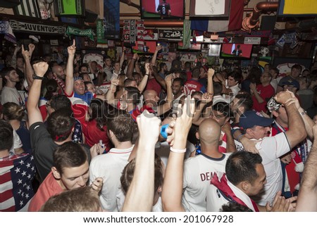 New York, NY USA - JUNE 26: Fans of the United States Men\'s National Soccer Team celebrate after United States advanced to second round of World Cup inside Legends sport Bar