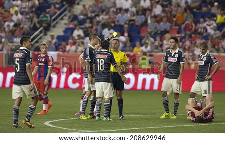 Harrison, NJ - JULY 31, 2014: Edgar Solis (18) of CD Guadalajara receives yellow card during friendly match between CD Guadalajara Chivas and FC Bayern Munich at Red Bull Arena