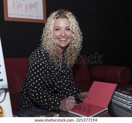 New York, NY - October 18, 2014: Author Tiffany Beveridge signs her book during PetiteParade Kids Fashion week at Bath House Studios