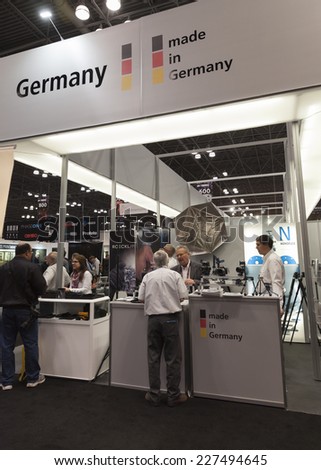NEW YORK, NY - November 1, 2014: Representatives of German companies talk to visitors at Germany trade booths at Photoplus expo organized by Photo District News at Javits Convention Center