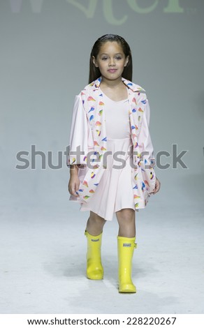 New York, NY - October 18, 2014: Girl walks runway for Oil & Water design at PetiteParade Kids Fashion week at Bath House Studios