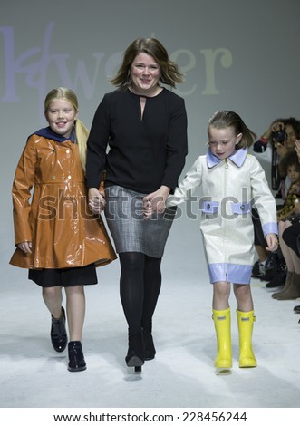 New York, NY - October 18, 2014: Designer Amy Wismar and girls walk runway for Oil & Water design at PetiteParade Kids Fashion week at Bath House Studios
