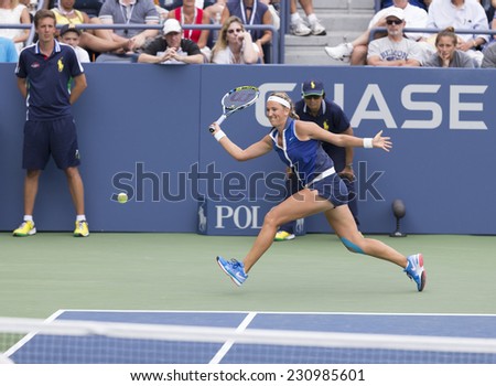 NEW YORK, NY - AUGUST 30, 2014: Victoria Azarenka of Belarus returns ball during 3rd round match against Elena Vesnina of Russia at US Open tennis tournament in Flushing Meadows USTA Tennis Center