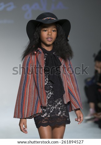 New York, NY - February 28, 2015: A model walks the runway for Little Miss Galia collection by Alia Charvel during petitePARADE / Kids Fashion Week at Bathhouse Studios