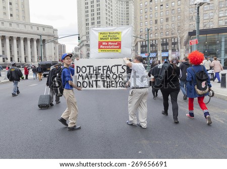 New York, NY - April 14, 2015: Protesters against police brutality walk down around Foley SQuare with sign against CNN reports