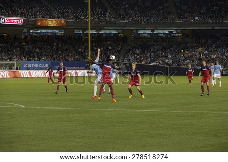 New York, NY - May 15, 2015: Lovel Palmer (5) of Chicago Fire and David Villa of NYCFC (7) fight for the ball during the game between New York City Football Club and Chicago Fire FC at Yankee Stadium