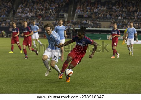 New York, NY - May 15, 2015: Lovel Palmer (5) of Chicago Fire & Mix Diskerud of NYCFC (10) fight for the ball during the game between New York City Football Club and Chicago Fire FC at Yankee Stadium