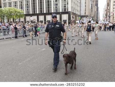 NEW YORK, NY - MAY 31, 2015: NYPD police officer with dog from K9 Unit attends Celebrate Israel Parade on 5th avenue in Manhattan