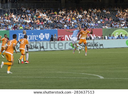 New York, NY - May 30, 2015: Mix Diskerud (10) of NYCFC & Giles Barnes (10) of Houston Dynamo fight for ball during the game between New York City Football Club and Houston Dynamo at Yankee Stadium