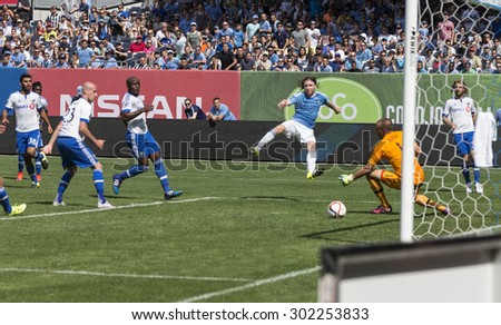 New York, NY - August 1, 2015: Thomas McNamara (15) scores goal as Evan Bush didnÃ?Â¢??t catch ball during game between New York City FC and Montreal Impact at Yankee Stadium