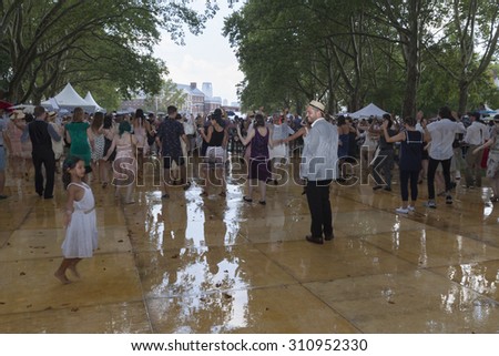 New York, NY USA - August 16, 2015: Dancing under rain during 10th annual Jazz Age lawn party by Michael Arenella & Dreamland Orchestra on Governors Island