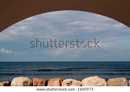 Winter view of Mediterranean sea through the arch on embankment of city of Haifa, Israel.