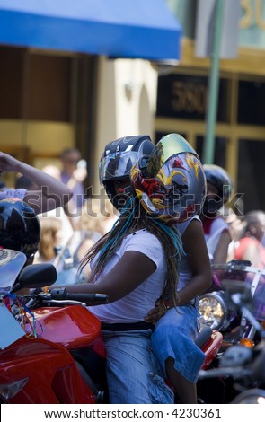 african-american women ride motorcycle on pride parade in New York