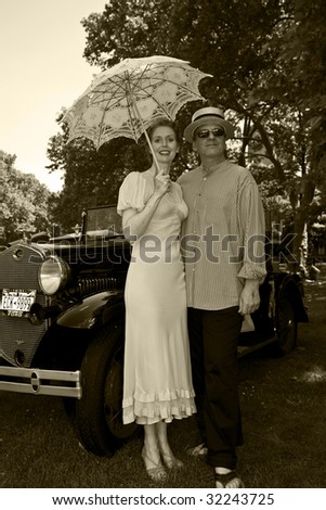 NEW YORK - JUNE 6: Couple in period clothing in front of antique car at 5th Annual Jazz age concert and picnic on Governors Island on June 6 2009 in New York