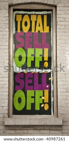 Huge sell off sign in a window