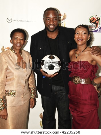 NEW YORK - DECEMBER 04: South African Consul General Fikile Magubane, actor Malik Yoba and singer Celia Faussart celebrate the launch of the new FIFA collection and draw of World Cup on Dec 4, 2009