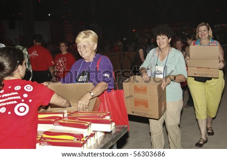 NEW YORK - JUNE 29: Unidentified volunteers help assemble meals at \'Target Party for Good\' South Street on June 29, 2010 in New York City.