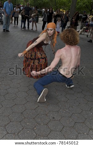 NEW YORK - MAY 21: Unidentified couple dances in Tompkins Square park as part of New York Dance Parade on May 21, 2011 in New York City