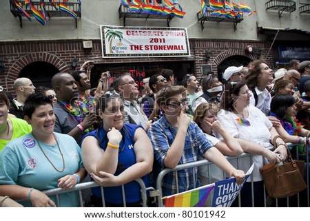 NEW YORK - JUNE 26: Unidentified revelers lined up along the march route at Stonewall bar during Pride march along Fifth Avenue at pride parade on June 26, 2011 in New York City.