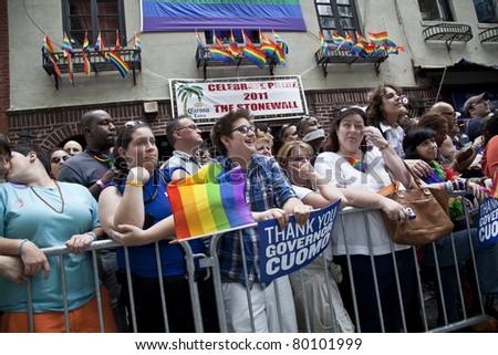 NEW YORK - JUNE 26: Unidentified revelers lined up along the march route at Stonewall bar during Pride march along Fifth Avenue at pride parade on June 26, 2011 in New York City.